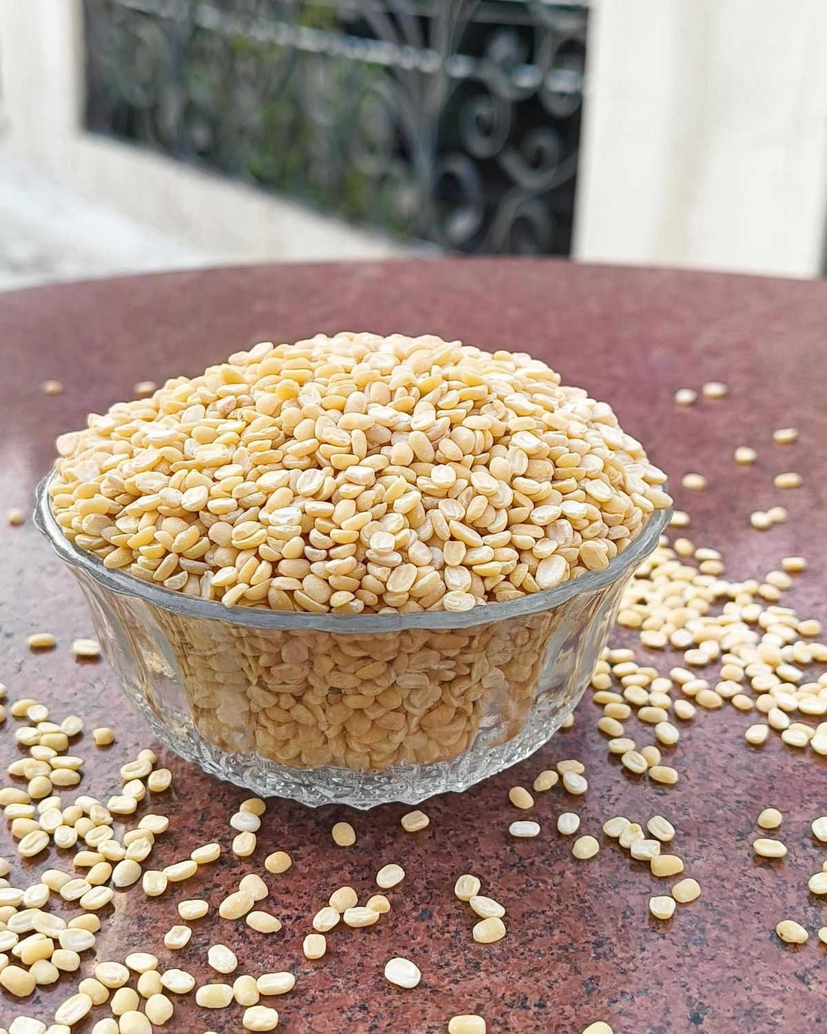 Real hands inspecting delicate split yellow moong grains