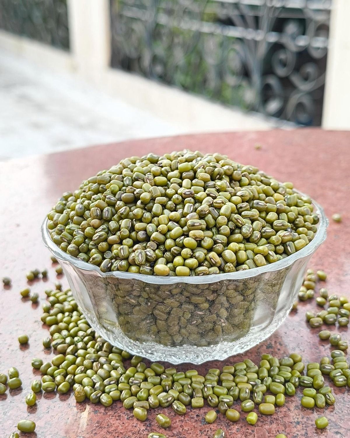 Whole green moong in clear glass dish